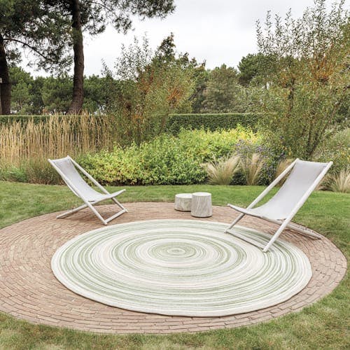 retreat: an outdoor levante rug in color mystic green sets the scene