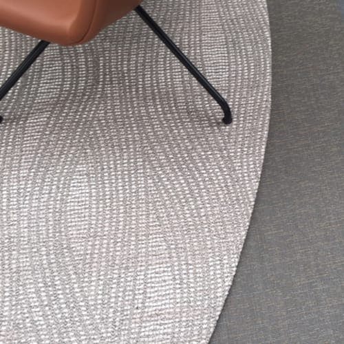 infinite: folded edge finish of alfresco wave in marblewhite as a circular rug