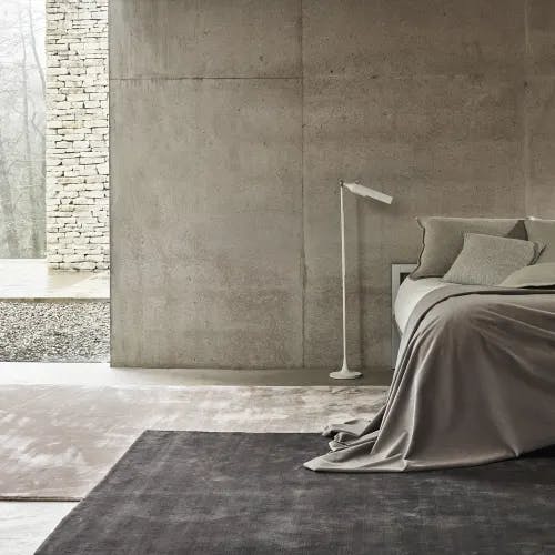 Layered Jacaranda Kheri Cameo & Amethyst rugs in a modern industrial bedroom