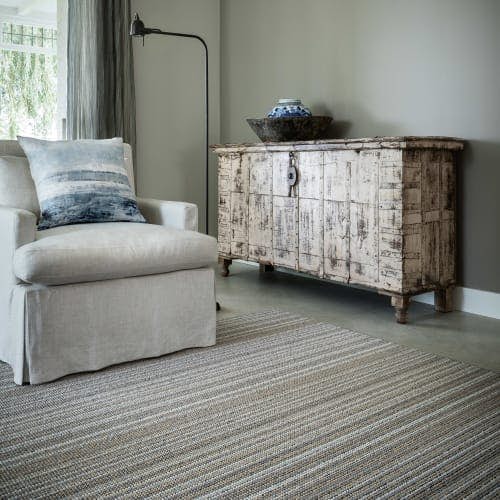 Masai Nude wool rug in living room with lounge chair